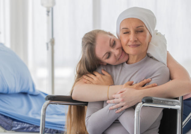 Woman hugging cancer patient